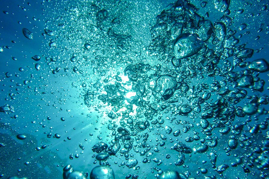 Oxygen bubbles under water.