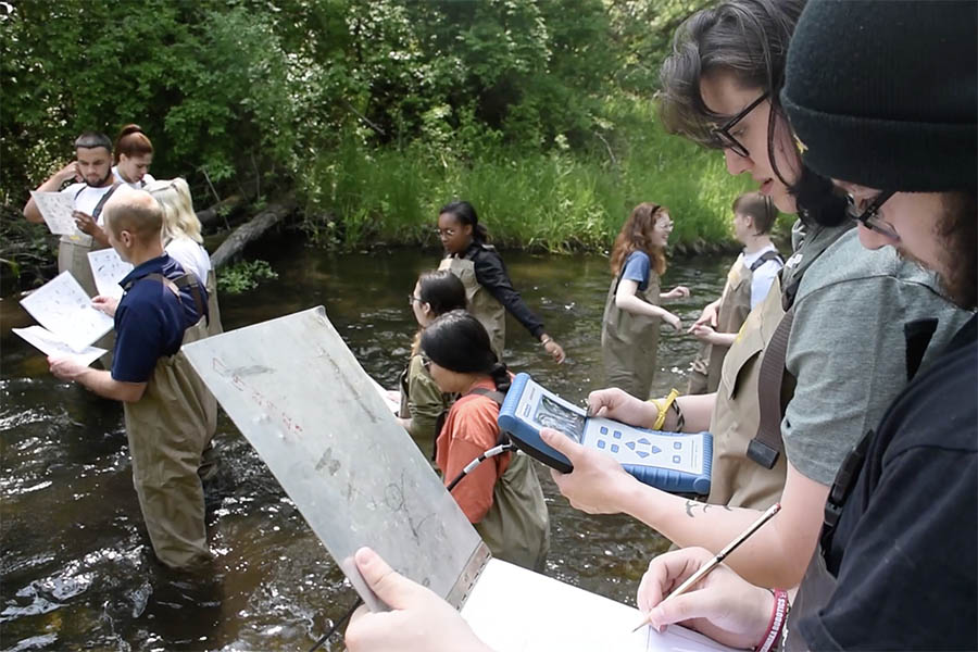 Students in stream collecting data.